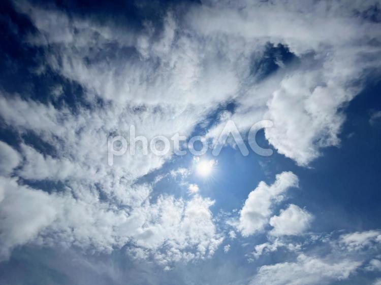 太陽のフレアと爽やかな青空と雲の背景素材 フレア,青空,空の写真素材