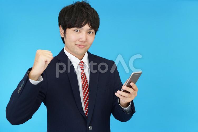 スマートフォンを持つビジネスマン 男性,ビジネスマン,スマホの写真素材
