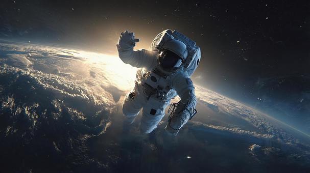 地球の軌道で浮遊する宇宙飛行士 地球の軌道で浮遊する宇宙飛行士の写真