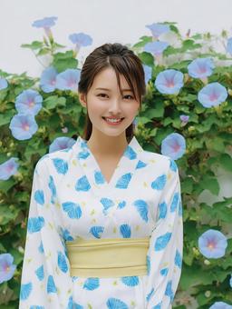 朝顔を背景に朝顔柄の浴衣を着た女性の写真