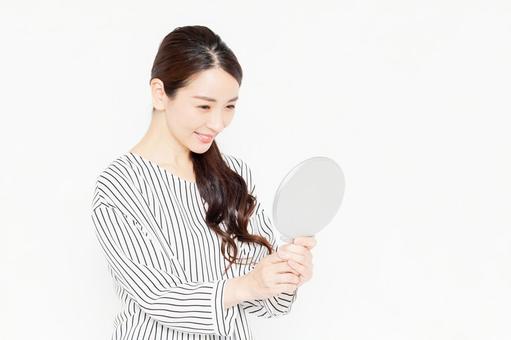 Casually dressed female holding a hand mirror, hand mirror, female, to see, JPG