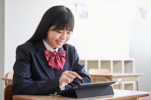 Junior high school girls operating tablets in the classroom, middle school students, woman, japanese, JPG