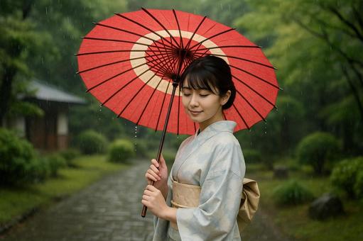 雨の庭園に立つ着物女性 雨の庭園に立つ着物女性の写真