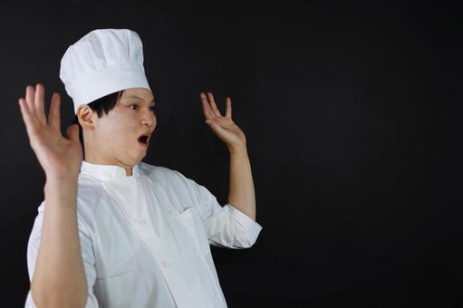 驚きのポーズをとるシェフ 驚きのポーズをとるシェフの写真