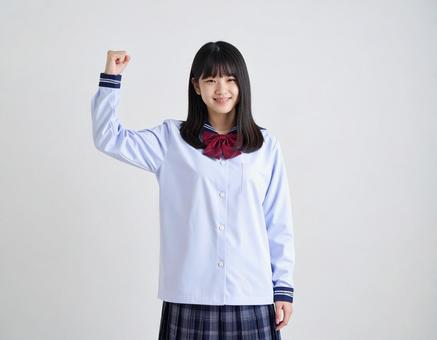 ガッツポーズをする女子生徒のイメージ ガッツポーズをする女子生徒のイメージの写真