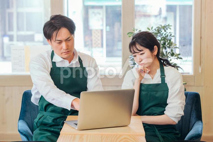 レストラン・カフェ・飲食店を経営する男女 ネットショップ,オンラインショップ,パソコンの写真素材