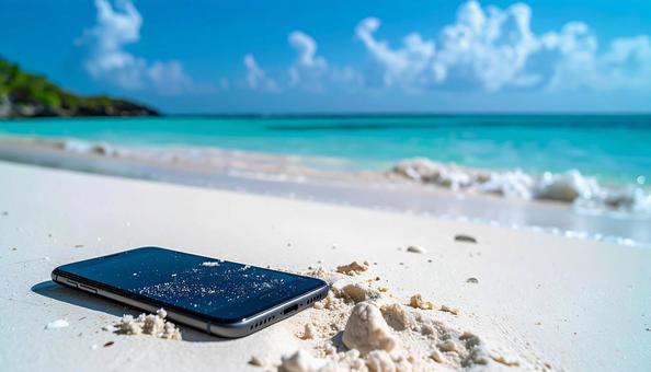 砂浜に置かれたスマートフォン 砂浜に置かれたスマートフォンの写真