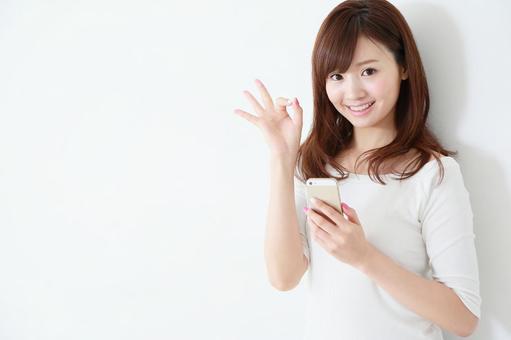 スマートフォンを使う女性 スマートフォンを使う女性 スマートフォン,カジュアル,調べるの写真素材