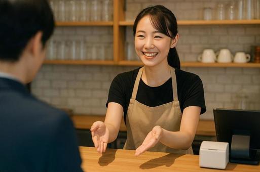 カフェで接客する飲食店女性スタッフ カフェで接客する飲食店女性スタッフの写真