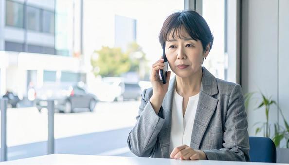 困った表情で電話する中年 困った表情で電話する中年の写真