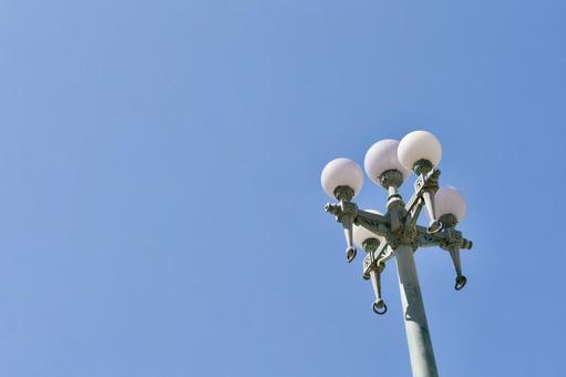 Retro street lamp silhouette against the blue sky, JPG