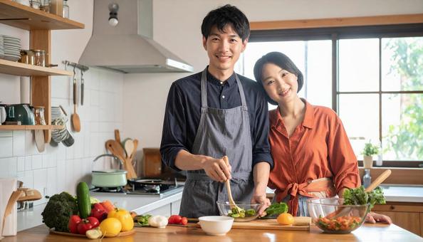 料理する日本人の若い夫婦 料理する日本人の若い夫婦の写真
