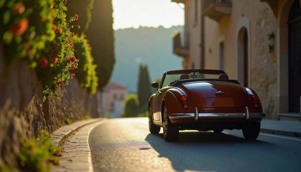 古い町並みの街角に止められたオープンカーの写真