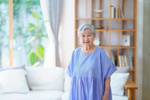 カメラ目線で微笑むワンピースの高齢女性 女性,微笑む,笑顔の写真素材