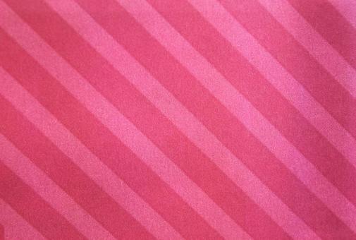 赤いストライプ柄の布地のテクスチャ ストライプ,縞模様,ピンクの写真素材