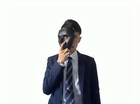 黒い仮面で顔を隠すスーツ姿の男性 秘密,セキュリティ,仮面の写真素材