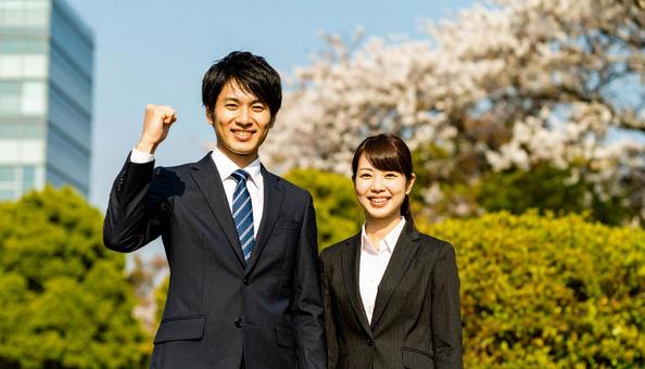 ガッツポーズをする笑顔のビジネスマン男女 ガッツポーズをする笑顔のビジネスマン男女の写真