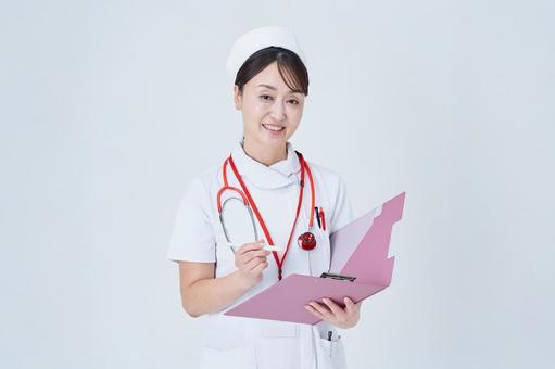 問診する医療スタッフの女性 問診する医療スタッフの女性 問診,カルテ,質問の写真素材