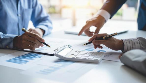 企画会議 グラフが書かれた書類と電卓 企画会議 グラフが書かれた書類と電卓の写真