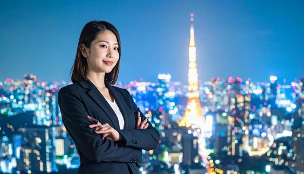 都市の夜景を背景に佇むビジネスマン 都市の夜景を背景に佇むビジネスマンの写真