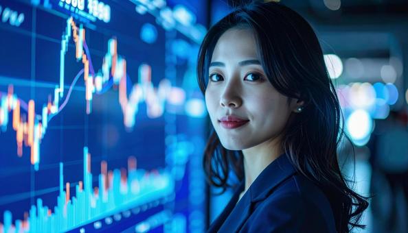 ディルプレイのチャートの前に立つ女性社員の写真