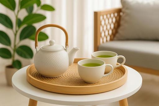 白い急須と緑茶のティータイムの写真