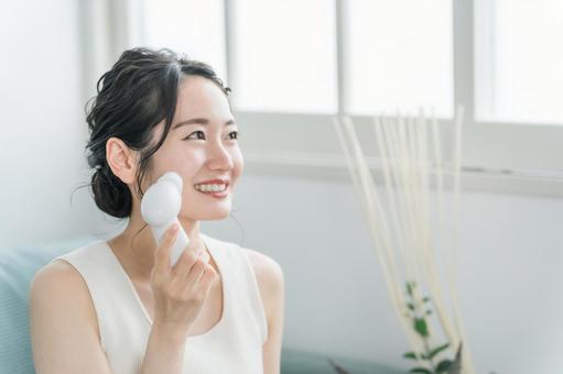 洗顔器・洗顔ブラシを使って洗顔する女性  洗顔器・洗顔ブラシを使って洗顔する女性 の写真
