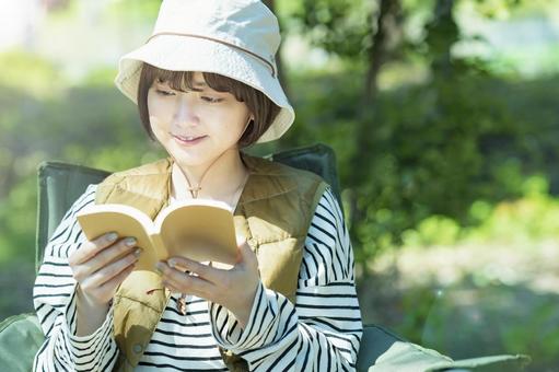 Solo camp image-Young woman reading a book, camp, solo camp, female, JPG