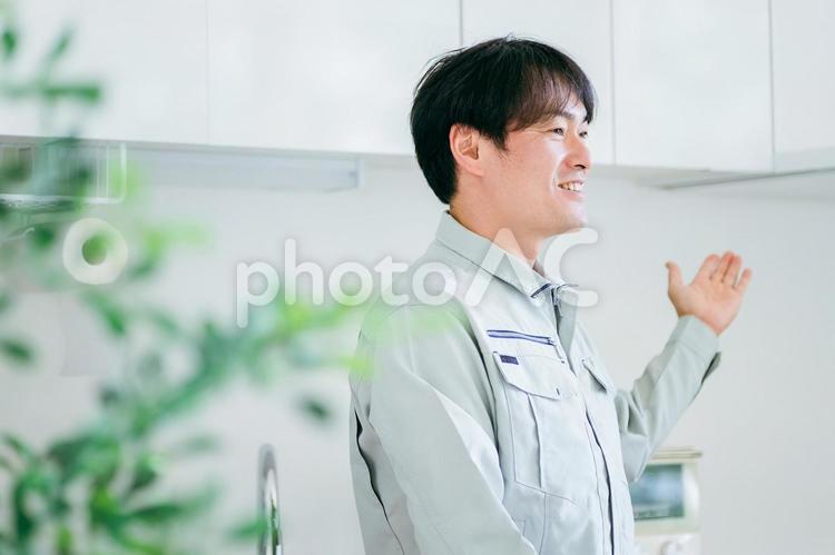 キッチンと作業着姿の男性 工務店,作業服,設備の写真素材