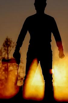 Silhouette of a powerful man standing against the setting sun, JPG Silhouette of a powerful man standing against the setting sun, JPG