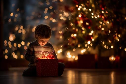 光あふれるプレゼントを開ける男の子の写真