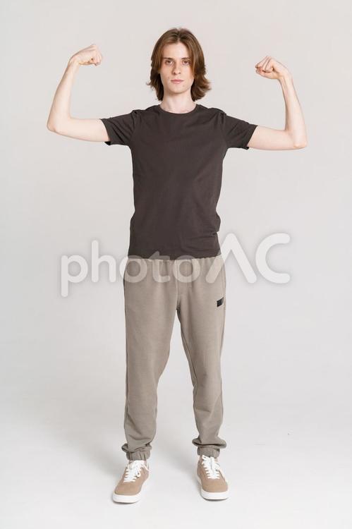 両腕で力こぶポーズをする男性 男性,力こぶ,ポーズの写真素材