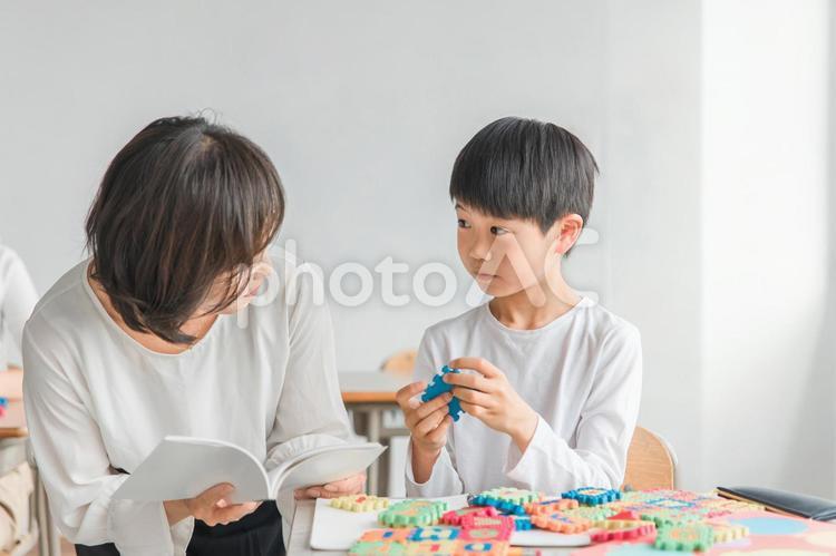 教室で英語を勉強する男の子と女性講師 英語,小学生,子供の写真素材