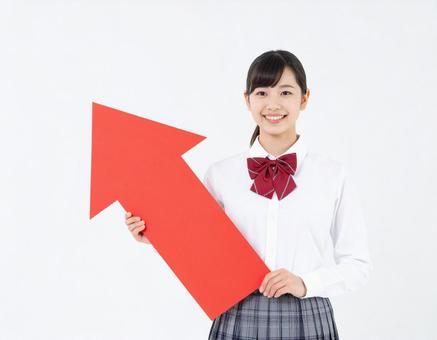 上向き矢印のオブジェを持った女性 上向き矢印のオブジェを持った女性の写真