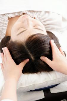 Hands of women and practitioners receiving scalp massage Hands of women and practitioners receiving scalp massage