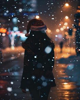 クリスマス サンタ帽子 女性 雪 夜 クリスマス サンタ帽子 女性 雪 夜の写真