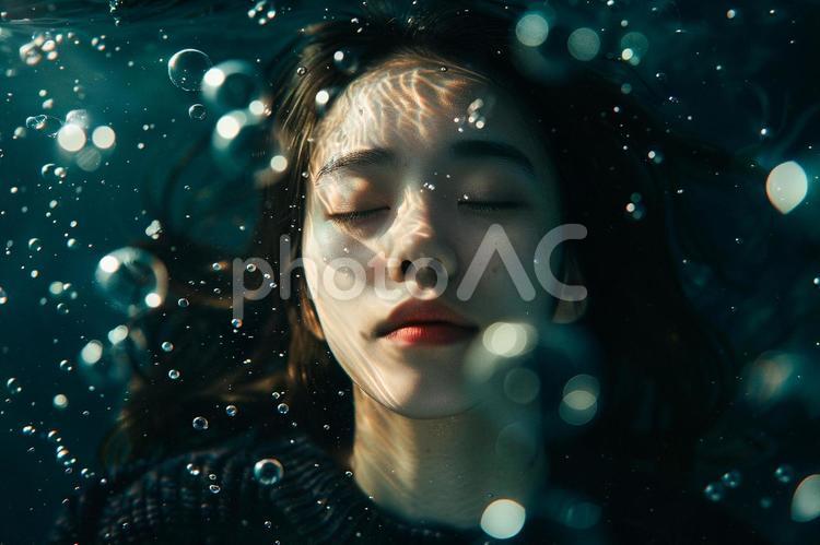 泡に囲まれた水中の女性 女性,水に浮かぶ,目を閉じるの写真素材