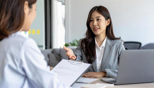 保険の案内をする女性の保険外交員 保険の案内をする女性の保険外交員の写真