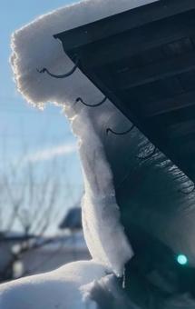 晴れた日に屋根から滑り落ちる積雪 晴れた日に屋根から滑り落ちる積雪 雪,落雪,積雪の写真素材