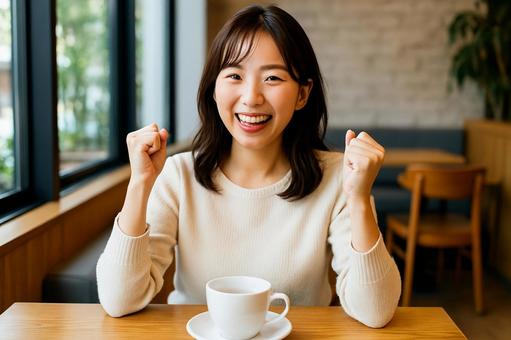 カフェで喜ぶ女性 カフェで喜ぶ女性の写真