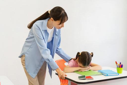泣いている女の子を慰める先生 女性,女の子,子どもの写真素材