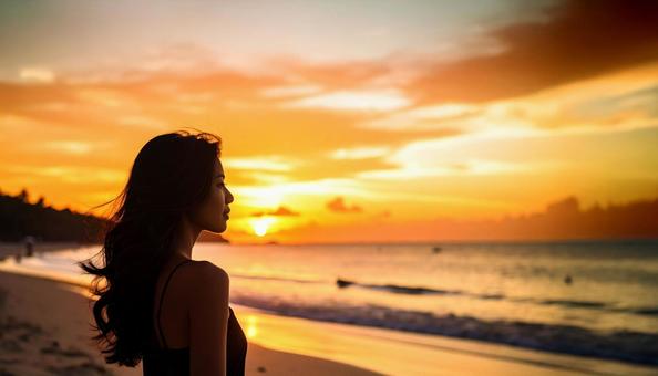 夕暮れのビーチと夕陽・女性のシルエット 夕暮れのビーチと夕陽・女性のシルエットの写真