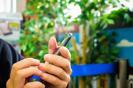 Hands to operate the smartphone Hands to operate the smartphone