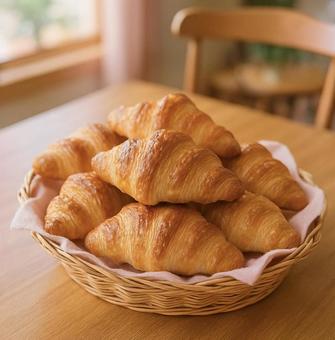 かごにたっぷり入った焼きたてクロワッサンの写真