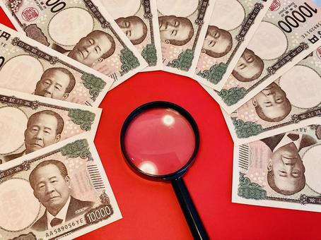 10,000 yen bills placed around a magnifying glass, JPG