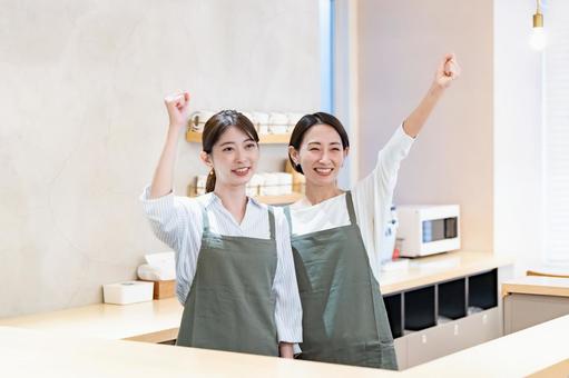 ガッツポーズをするカフェ店員 飲食店,店員,職場の写真素材