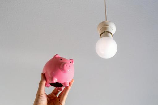 Pink piggy bank and LED lighting hanging from the ceiling Pink piggy bank and LED lighting hanging from the ceiling
