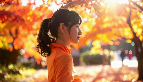 紅葉の中　スポーツウェアを着た女性の写真