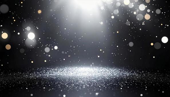 きらめく光の粒子と暗闇の写真