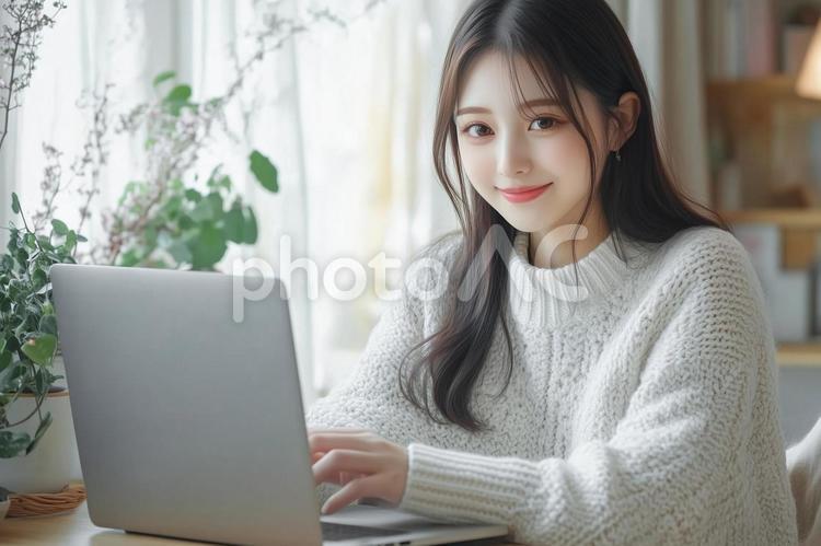 部屋でノートパソコンを操作する若い女性 女性,若い,ノートパソコンの写真素材